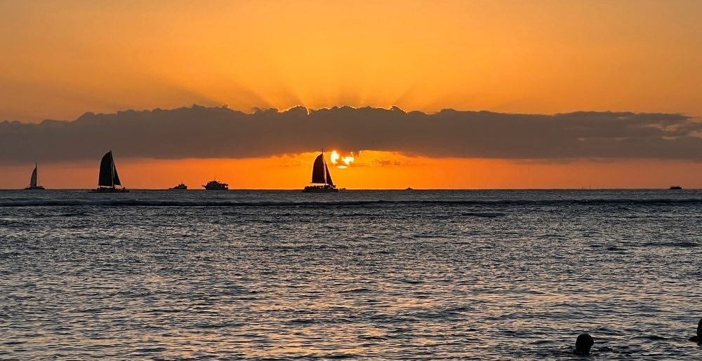 sailboat at sunset seen on a sunset cruise in honolulu