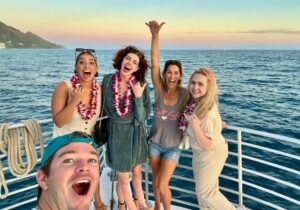 people excited and posing for the camera on a boat tour in Honolulu