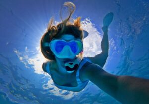 person wearing a snorkeling mask on a boat tour in Honolulu